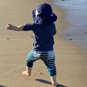 baby running on beach